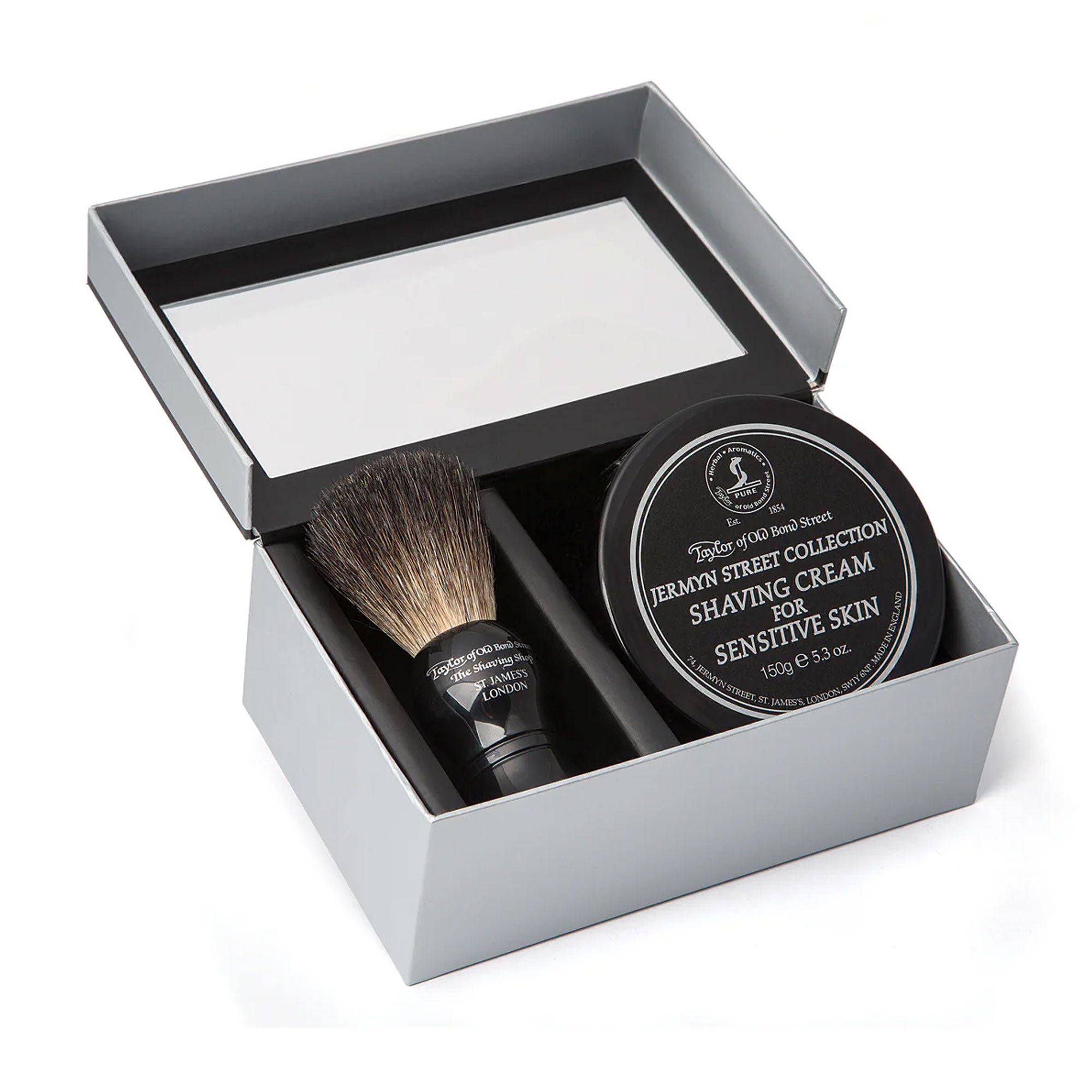 Shaving brush and cream set in a box on a white background